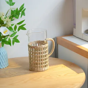 Handmade glass cup with natural woven rattan sleeve detail shot, perfect for home decor and bar use.