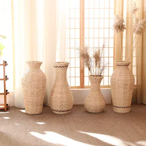 Handmade rattan woven flower vase set with dried reed plants for home decor and interior display details.