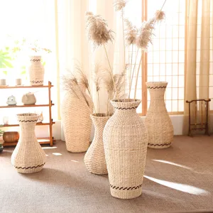 Natural straw woven floor vase for dried flowers, rustic home decor wicker flower arrangement.
