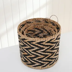 European style woven straw storage basket with metal handles, nesting design for home organization.