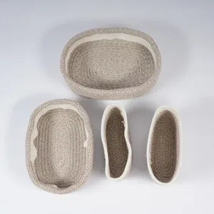 Woven cotton rope storage basket set, oval organizer bins for home organization and decor use.