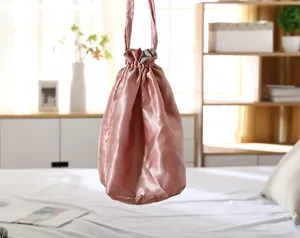 Pink satin drawstring pouch, elegant silky storage bag, portable makeup and cosmetic organizer.