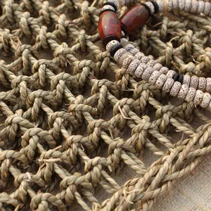 Detailed view of the natural straw woven pet mat and cat scratching board with bead decor.