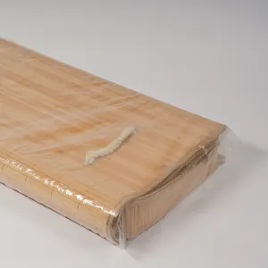 Detailed view of folded bamboo woven storage basket with rope handle, natural material.