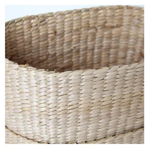 Handmade woven seagrass basket close up natural straw storage bag beach bag texture.
