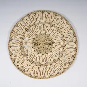 Handmade woven straw placemat close-up, showing intricate corn husk wave texture and details.