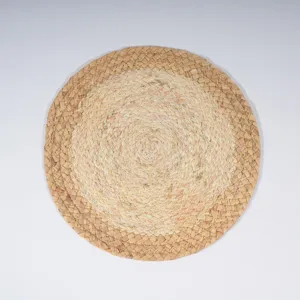 Handwoven straw placemat detail, natural plant fiber heat resistant pad for dining table decor.