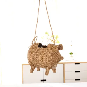Handmade straw woven cute pig shaped bag detail view, perfect summer beach shoulder bag style.