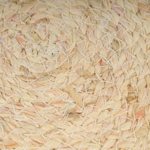 Handmade straw woven trivet macro texture, natural plant fiber heat resistant mat.