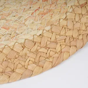 Close-up of handmade straw woven mat showing fine natural texture and durable weave details.