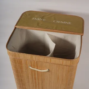 Bamboo laundry basket detail showing dual compartment divider and fabric lid with text print.