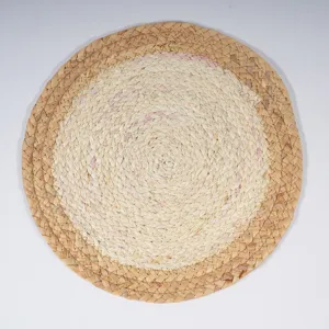 Handcrafted straw woven placemat detail showing natural texture and neat circular pattern.