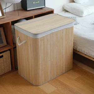 Bamboo laundry hamper basket with folding design fabric rim and rope handles for bedroom use.