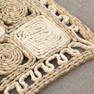 Handmade straw woven mat detail, natural texture and geometric pattern close up view.