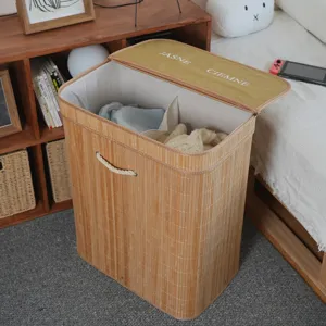 Detailed view of bamboo woven laundry hamper with lid and fabric partition for bedroom storage.