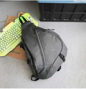 Grey teardrop sling backpack for men and women, casual outdoor sports chest bag for travel.