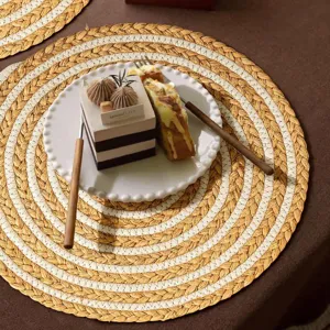 Handmade woven round placemat detail, raffia and cotton rope texture for heat insulation.
