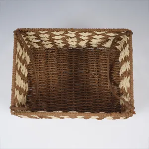 Handmade woven storage basket detail, brown and beige pattern, perfect for desktop organization.