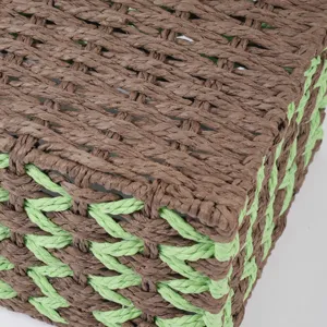 Close-up detail of the hand-woven brown and green paper rope storage basket texture and weave.
