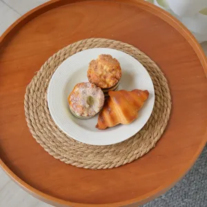 Handmade straw woven placemat detail showing natural texture and neat edge craftsmanship.
