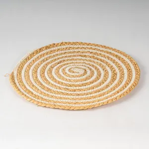 Detailed close-up view of the hand-woven raffia and cotton rope spiral patterned placemat.