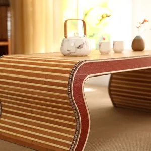 Close up view of curved bamboo tatami tea table edge showing fine craftsmanship and texture.