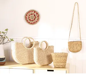 Detailed view of handmade cattail grass woven storage baskets and stylish straw bags on display.