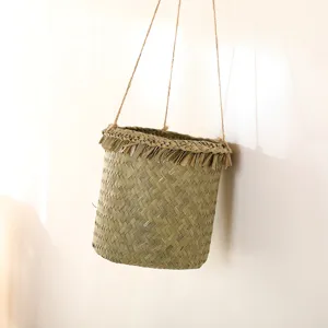 Handmade woven hanging basket detail showing natural texture, plant pot holder for home decor.