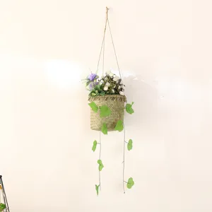 Handmade woven hanging basket detail, artificial flowers and green trailing vines decor