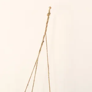 Detailed shot of handmade woven hemp hanging rope for flower basket, natural rustic texture.