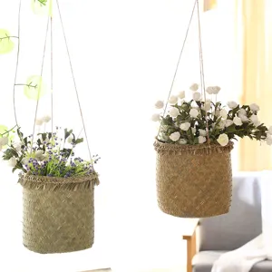 Hand-woven hanging basket rattan flower pot and storage basket for living room balcony decor.