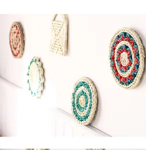 Detailed view of handmade straw woven wall hanging decors, natural texture and colorful patterns.