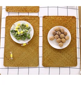 Detailed view of natural woven straw placemat, showcasing fine texture, heat resistant design.