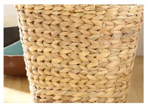 Handcrafted natural seagrass woven storage basket detail close up view natural straw material