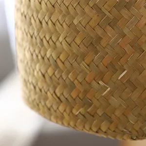 Detailed close-up view of handmade woven straw storage basket showing natural texture.