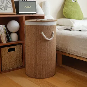 Detail of the cylindrical woven laundry hamper in a cozy bedroom scene with rope handles.