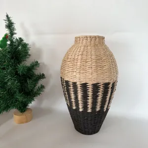 Handcrafted seagrass woven vase detail, two-tone natural and black tabletop decor piece.