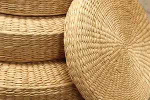 Close-up view showing the fine woven texture and natural straw material of the thick cushion.