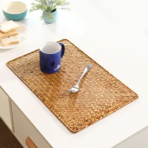 Natural straw woven placemat for dining table, thick heat resistant table mat detail view.