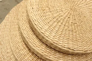 Detailed view of thickened straw woven meditation futon cushion, natural texture close up.