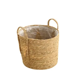 Natural straw woven flower basket with handles and waterproof liner for plant pot home decor.