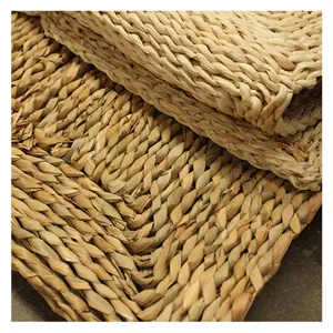 Natural corn leaf woven floor mat, eco-friendly hand-braided carpet for cozy home decor.