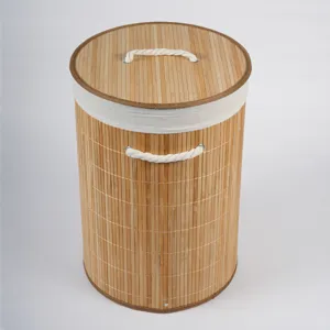 Detail view of the natural bamboo woven storage basket, featuring a clean lid and rope handles.