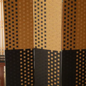 Detailed view of foldable woven room divider screen featuring geometric two-tone pattern.