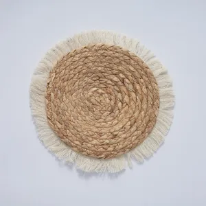 Bohemian round seagrass woven wall hanging decor with fringe, natural fiber boho home art.