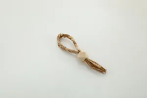 Handcrafted paper rope napkin ring with wooden bead for home and kitchen table decor.