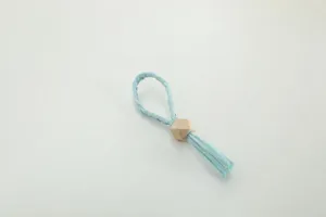 Handmade blue paper braided napkin ring with wooden bead for table decor and wedding party.
