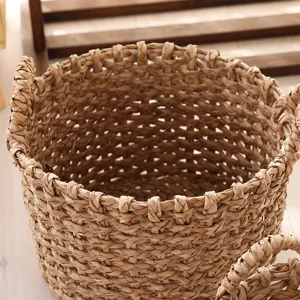 Handmade straw woven flower basket detail, natural seagrass plant pot holder for home decor.