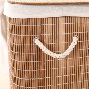 Close-up of bamboo laundry basket detail, natural woven bamboo slats with white rope handle.