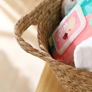 Handmade woven storage basket for laundry and home organization, natural straw material detail.